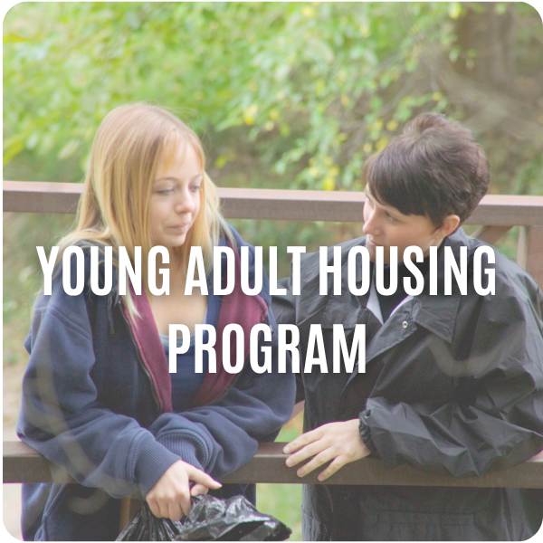 Two women stand outside talking by a wooden railing, with Young Adult Housing Program text over the image.